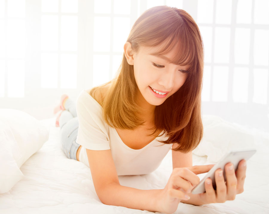 Woman scrolling through positive reviews on her phone. Woman scrolling through positive reviews on her phone.